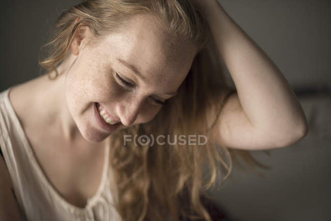 Portrait of young woman with freckles laughing — Stock Photo