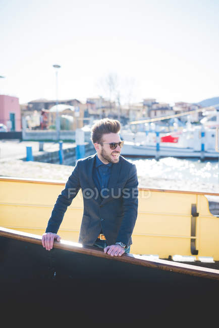 Young man looking out from lake ferry, Rovato, Brescia, Italy — Stock Photo