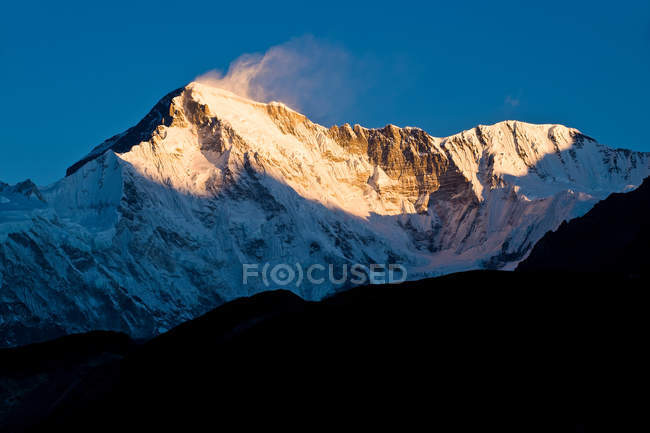 Snowy mountains overlooking valley — Stock Photo