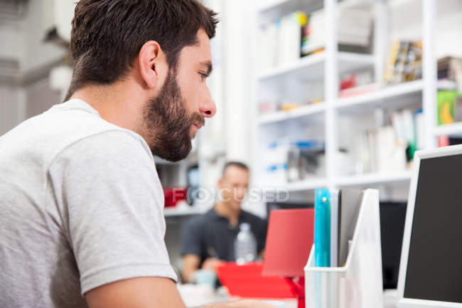 Male colleagues working in office — Stock Photo