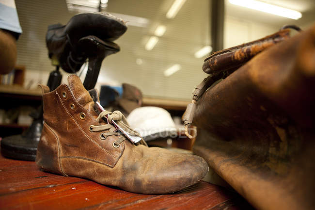 Close up of unfinished leather boot and bag — Stock Photo