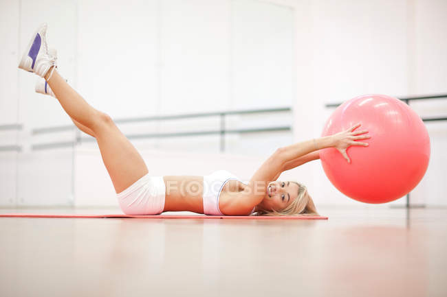 Junge Frau trainiert mit Gymnastikball — Stockfoto
