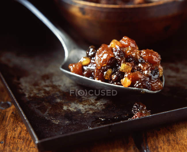 Close up of Spoonful of dried fruit mince pie filling on metal tray — Stock Photo