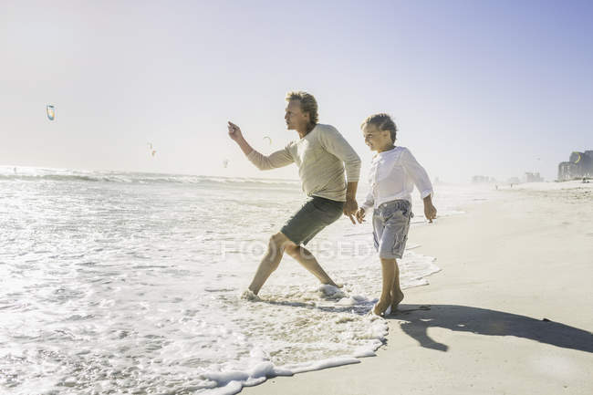 Father and son on beach — Stock Photo