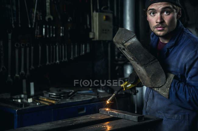 Welder soldering iron in workshop interior — Stock Photo