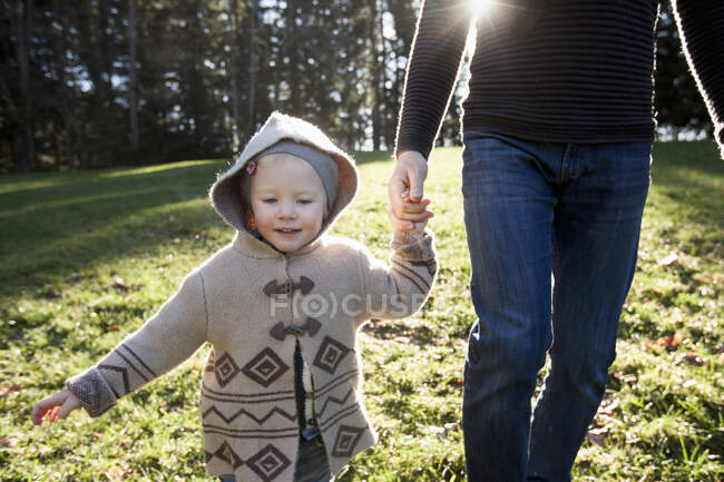 Mature man and toddler daughter out walking — Stock Photo