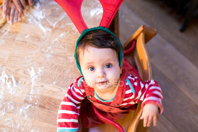 Portrait of baby boy wearing reindeer antlers — Stock Photo