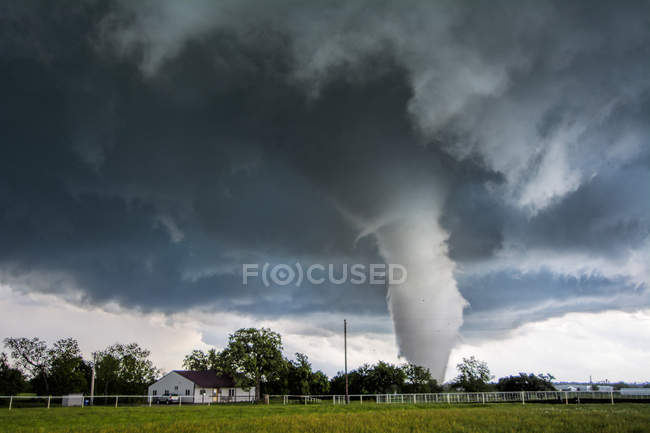 Storm cloud and tornado in countryside — Stock Photo