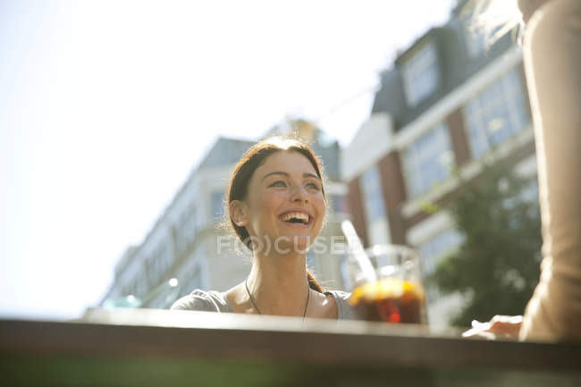 Friends enjoying drinks in pub, London — Stock Photo