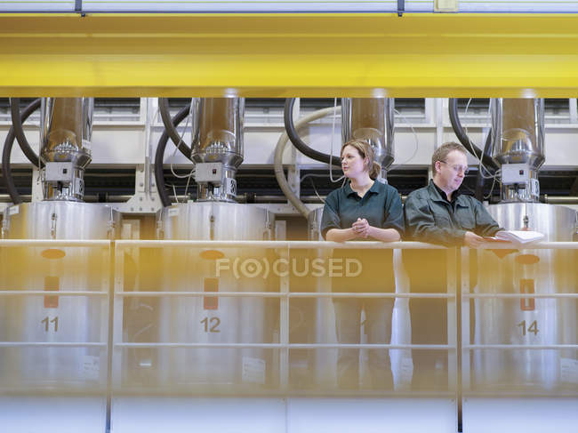 Workers on gantry in factory — Stock Photo