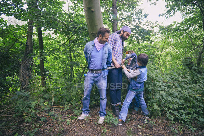 Two men captured by boys in forest — Stock Photo