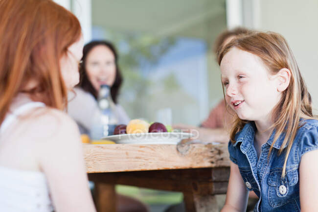 Girls talking at breakfast table — Stock Photo