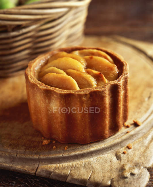 Pork pie topped with pear, on wooden chopping board, close-up — Stock Photo