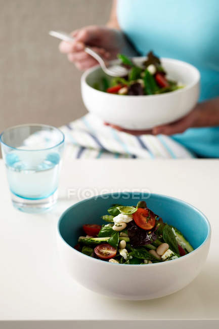 Cropped image of woman eating vegetable salad — Stock Photo