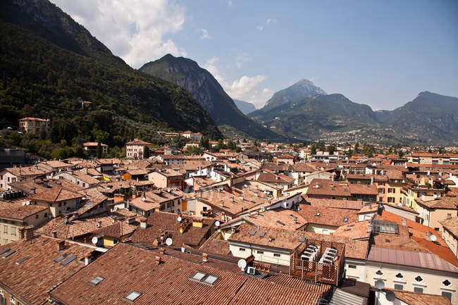 Aerial view of village rooftops with mountains on background — Stock Photo