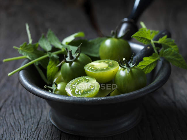 Sweet green cherry tomatoes with herbs — Stock Photo