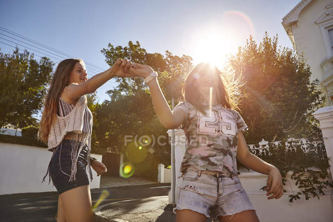 Teenage girls having fun in residential street, Cape Town, South Africa — Stock Photo