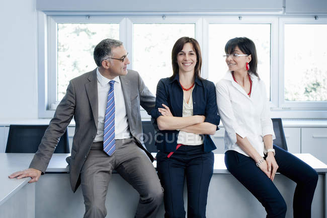 Бізнесмен і жінки роблять перерву в інтер'єрі офісу — стокове фото