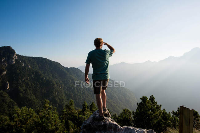 Veduta posteriore dell'uomo in piedi sulla vetta della montagna guardando altrove, Passo Maniva, Italia — Foto stock