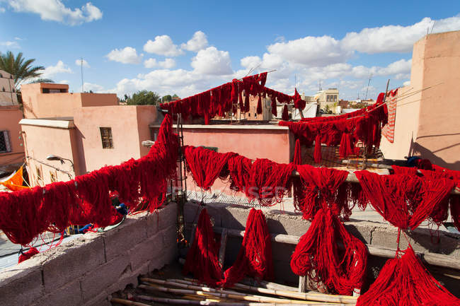 Dyed wool drying on lines — Stock Photo