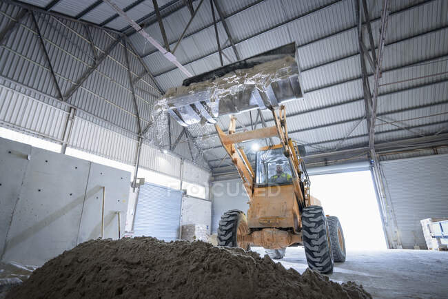 Digger with sand in architectural stone factory — Stock Photo