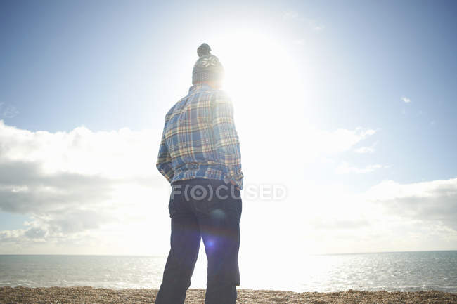 Homme mûr regardant vers la mer depuis la plage — Photo de stock