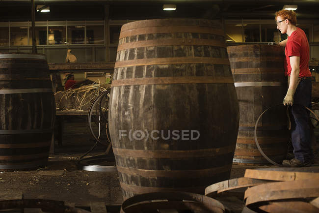 Young man working in cooperage — Stock Photo