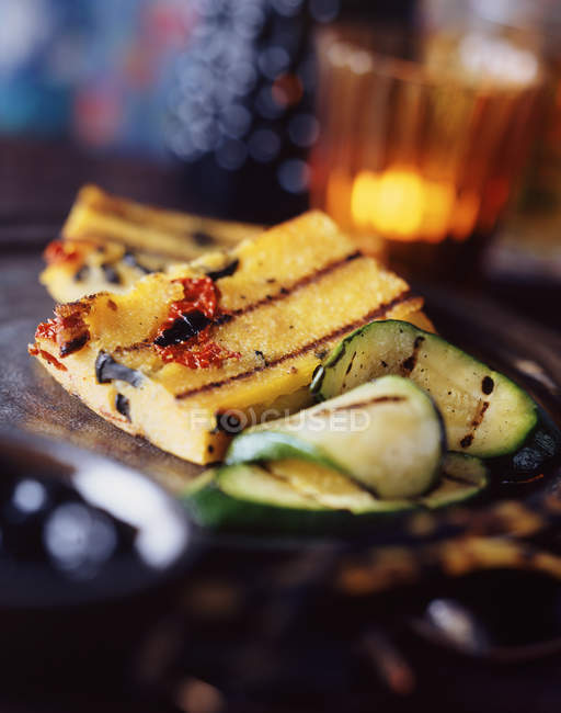 Frilled polenta with thinly sliced courgettes — Stock Photo
