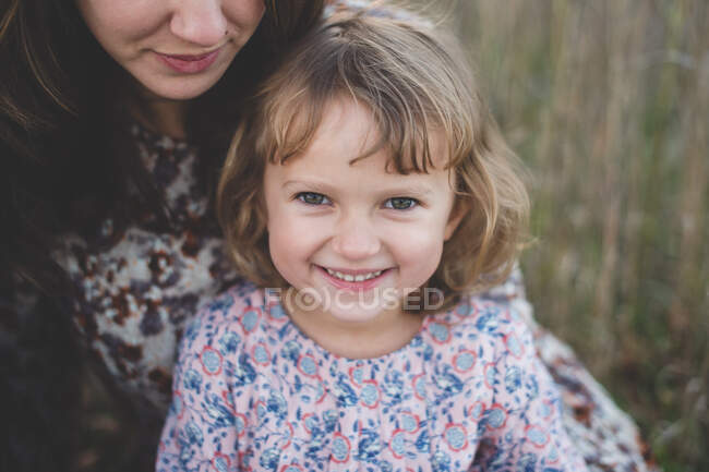 Close up portrait of young girl and mother — Stock Photo