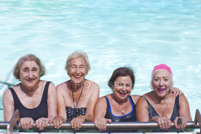 Portrait of four senior women in swimming pool — Stock Photo