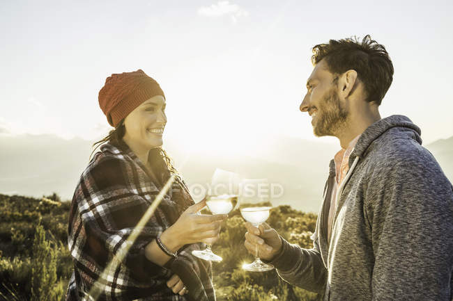 Couple in field making a toast — Stock Photo