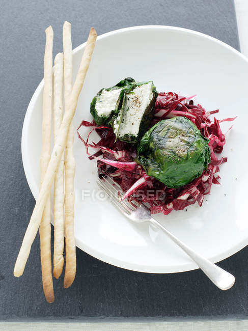Goat cheese in leaves — Stock Photo