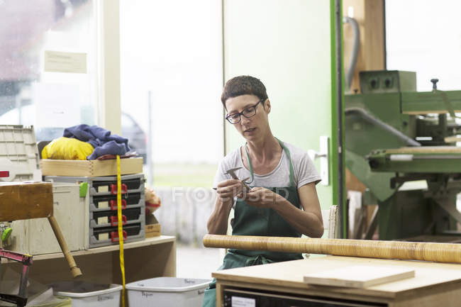 Woman in workshop making alphorn — Stock Photo
