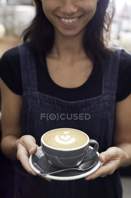 Portrait of Barista serving cappuccino — Stock Photo