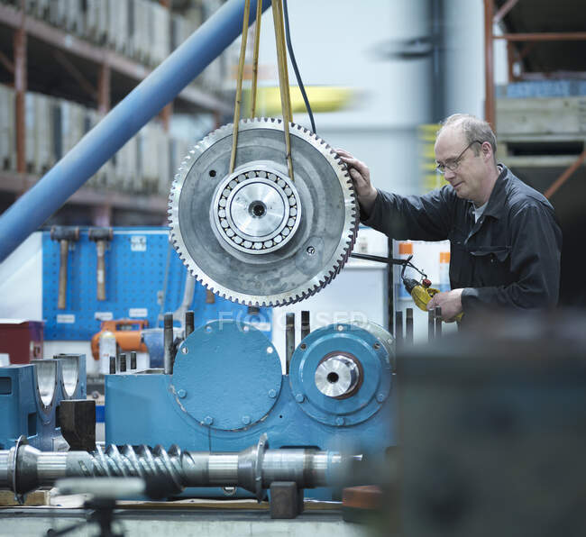 Engineer assembling industrial gearbox in engineering factory — Stock Photo