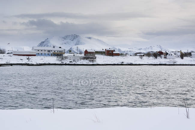 Snow covered landscape and distant houses, Andenes, Lofoten Islands, Norway — Stock Photo
