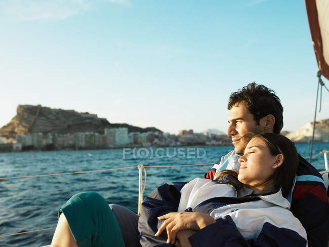 Young couple on yacht sitting portrait — Stock Photo