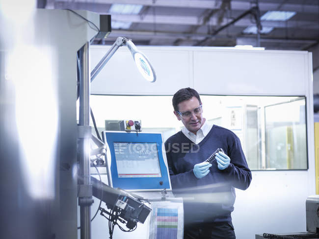 Чоловічий інженер тестує автомобільні запчастини на заводі — стокове фото