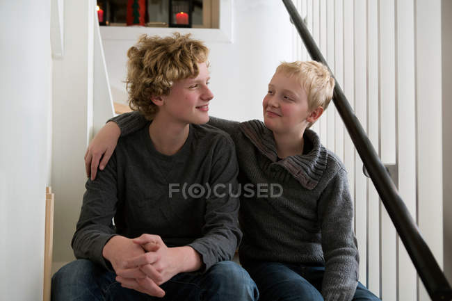 Boys sitting on stairs together — Stock Photo