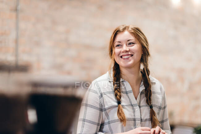 Glückliche junge Frau mit Zöpfen — Stockfoto