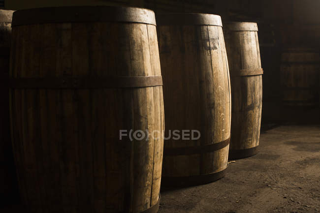 Wooden whisky casks in warehouse — Stock Photo