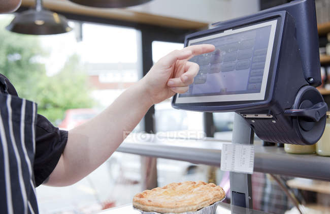 Cropped shot of butcher weighing pie in butchers shop — Stock Photo