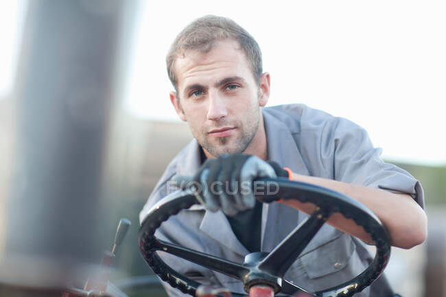 Young man at wheel of vehicle — Stock Photo