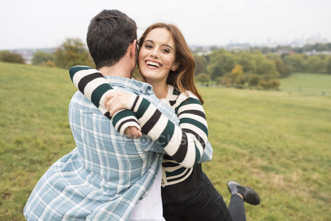 Couple hugging in field outdoors at daytime — Stock Photo