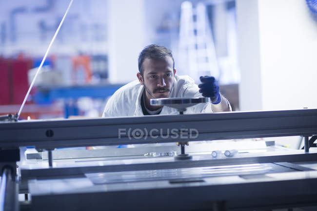 Young adult male Scientist operating heavy machinery — Stock Photo