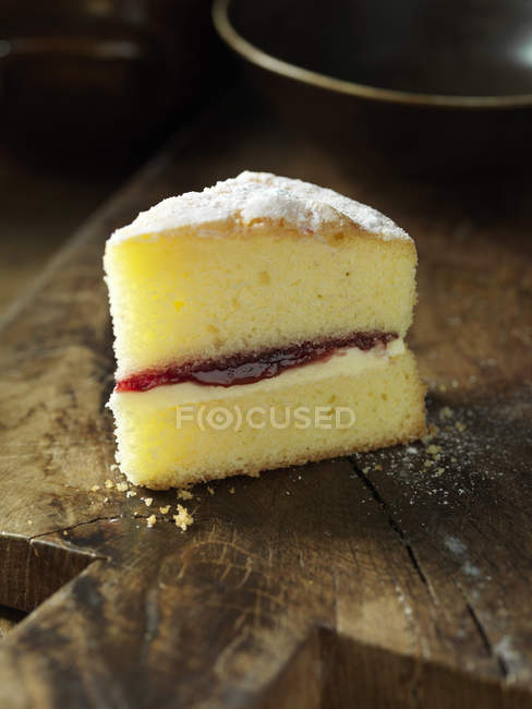 Gluten free Victoria sponge cake, jam, cream, wooden chopping board — Stock Photo