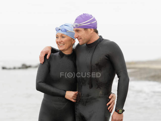 Divers smiling together on beach — Stock Photo