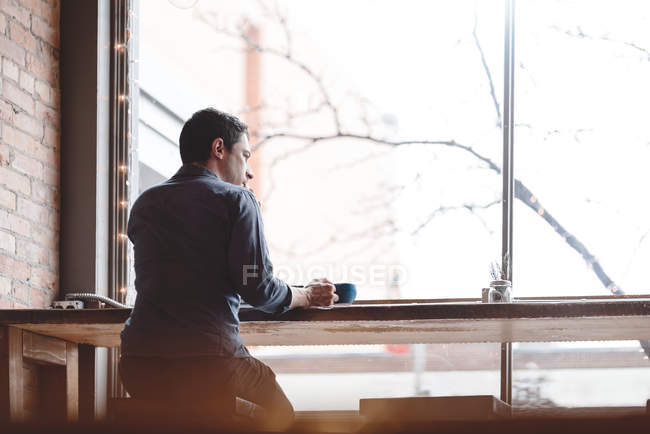 Man having coffee at cafe — Stock Photo