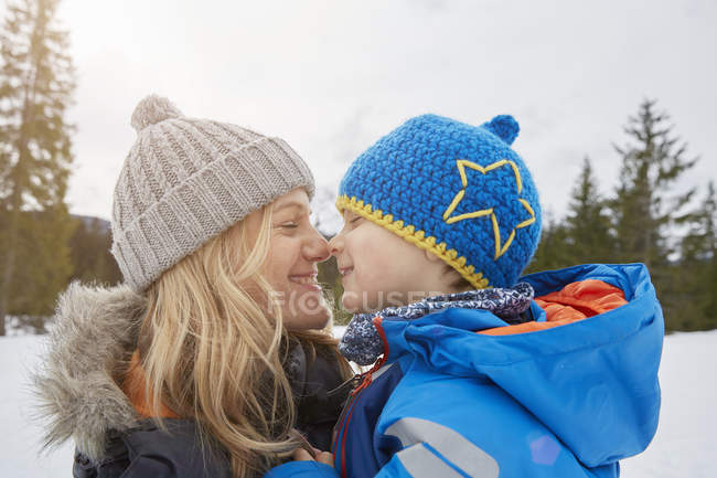Portrait of mother and son nose to nose in winter, Elmau, Bavaria, Germany — Stock Photo