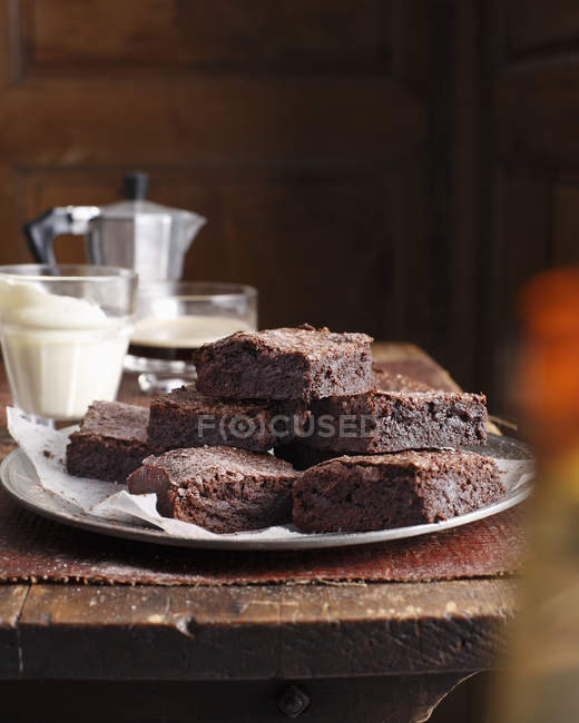 Stack of homemade chocolate brownies on plate — Stock Photo